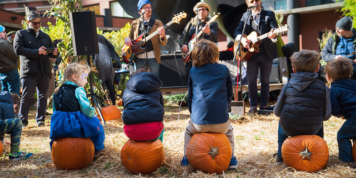 kids listening to music, kids sitting on pumpkins, pumpkin patch