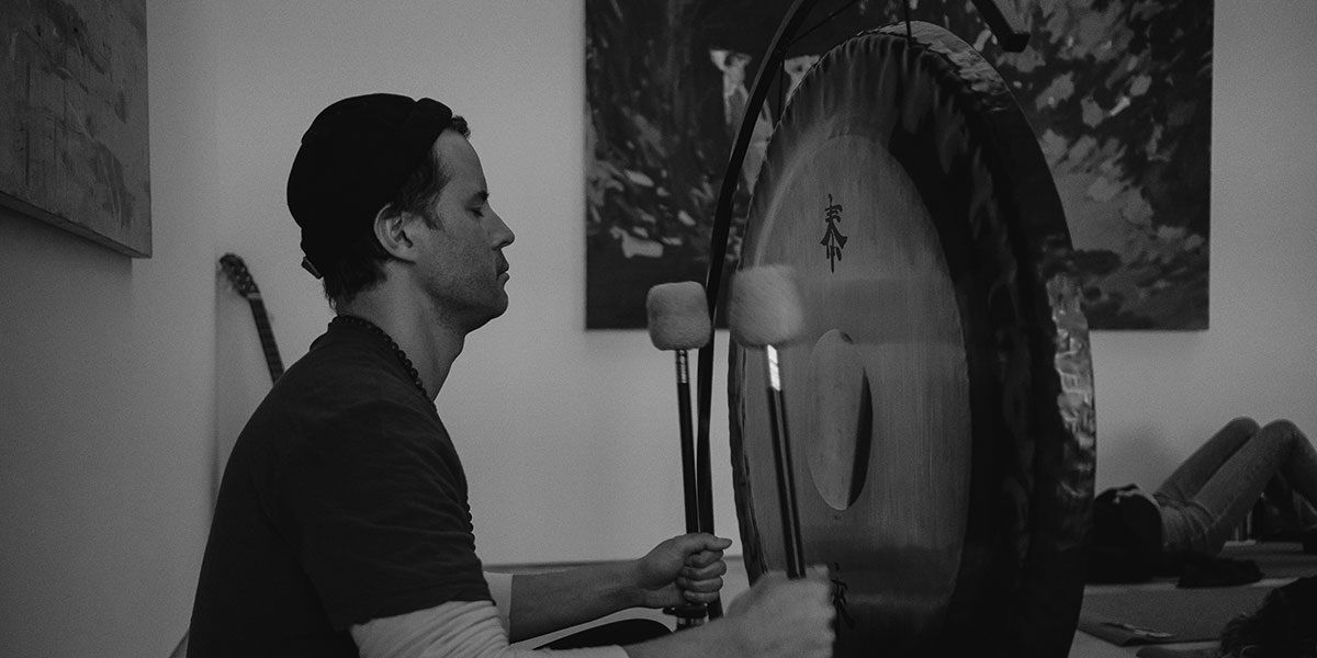 sound bath, man drumming, sound bath drum, black and white drumming
